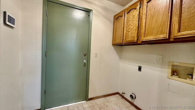 clothes washing area with cabinet space, baseboards, gas dryer hookup, hookup for a washing machine, and hookup for an electric dryer