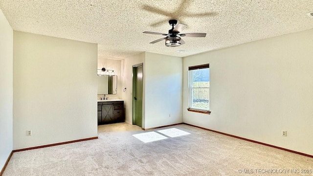 unfurnished bedroom featuring carpet floors, a textured ceiling, and baseboards