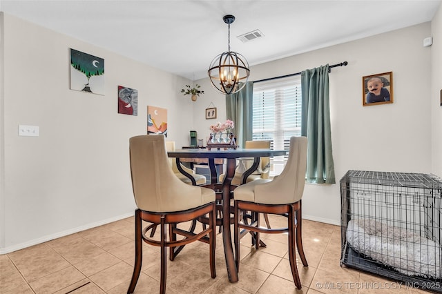 dining space featuring light tile patterned floors, a chandelier, visible vents, and baseboards