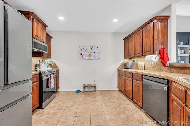 kitchen featuring light tile patterned flooring, stainless steel appliances, light countertops, decorative backsplash, and brown cabinetry