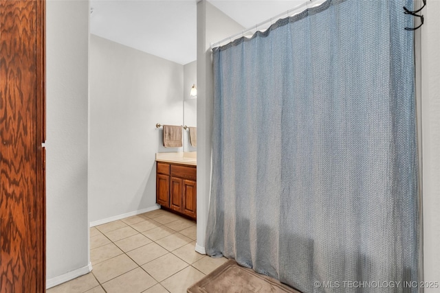 bathroom with tile patterned flooring, vanity, and baseboards