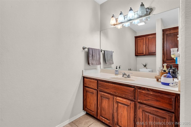 bathroom featuring tile patterned flooring, vanity, and baseboards