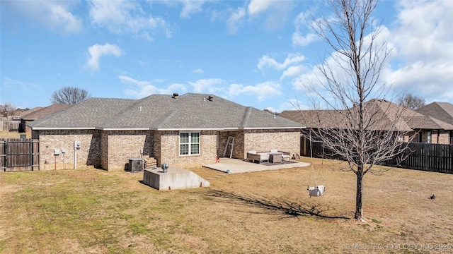 rear view of property with a lawn, a patio, a fenced backyard, cooling unit, and brick siding