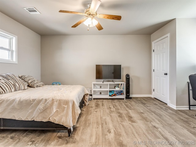 13902 S 241st E Ave, Coweta, OK 74429 - bedroom with wood finished floors, ceiling fan, and baseboards