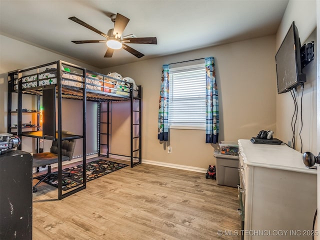 bedroom with wood finished floors, a ceiling fan, and baseboards