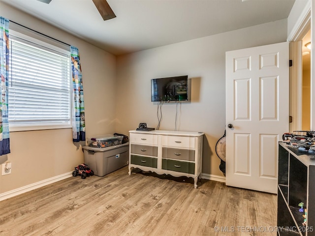 interior space with ceiling fan, baseboards, and wood finished floors