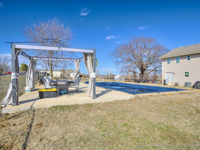 view of pool featuring a patio, cooling unit, fence, a lawn, and a fenced in pool