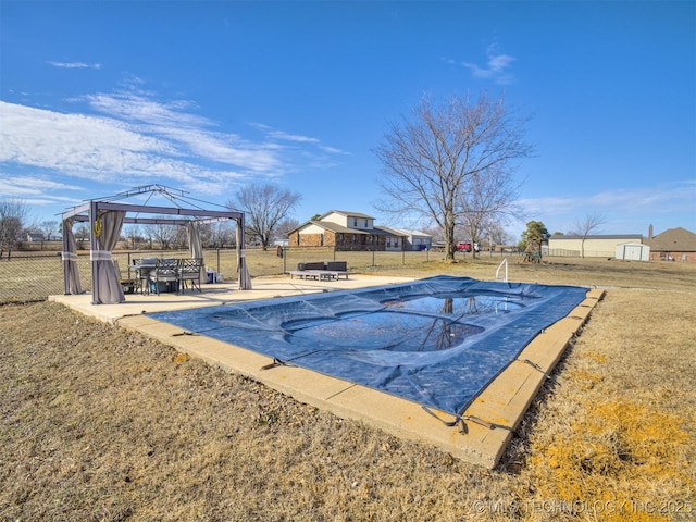 view of pool featuring a yard, fence, a fenced in pool, and a gazebo