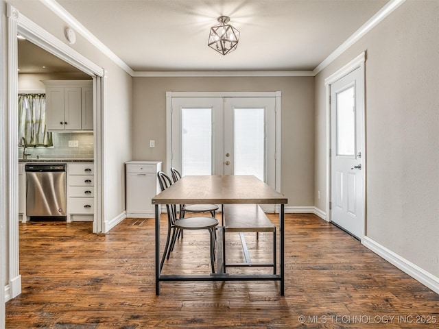 dining space featuring french doors, ornamental molding, and dark wood-style flooring