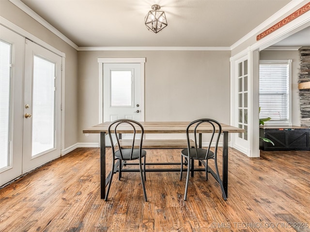 dining area featuring ornamental molding, french doors, baseboards, and wood finished floors