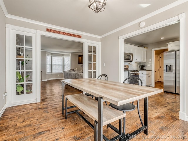 13902 S 241st E Ave, Coweta, OK 74429 - dining space with ornamental molding, wood finished floors, baseboards, and french doors