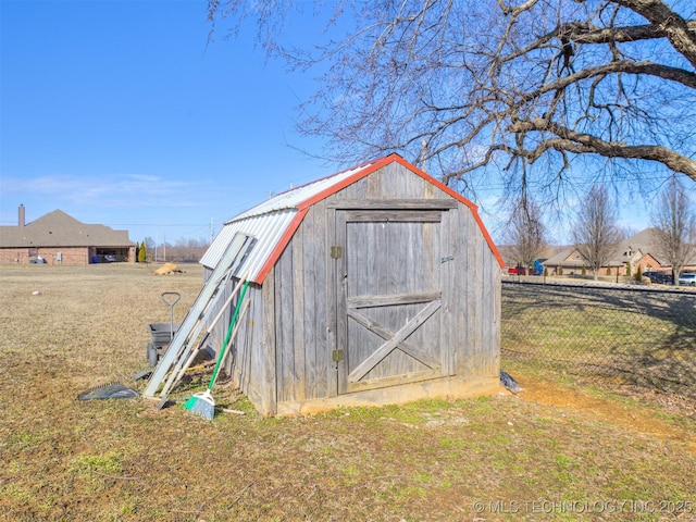 view of shed featuring fence