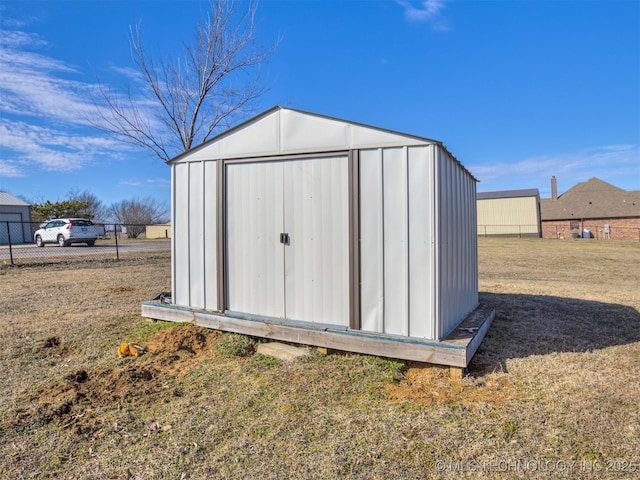 view of shed featuring fence