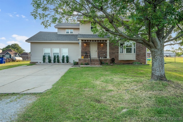 13902 S 241st E Ave, Coweta, OK 74429 - view of front of house with brick siding, concrete driveway, a front lawn, and a shingled roof