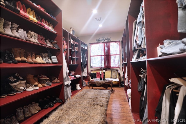 spacious closet featuring visible vents and wood finished floors