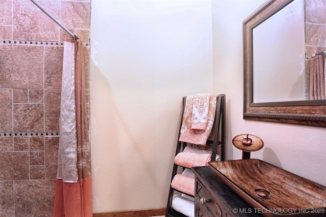 full bathroom with a tile shower