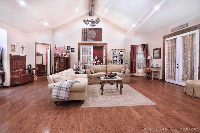 living room featuring high vaulted ceiling, french doors, dark wood-type flooring, and beam ceiling