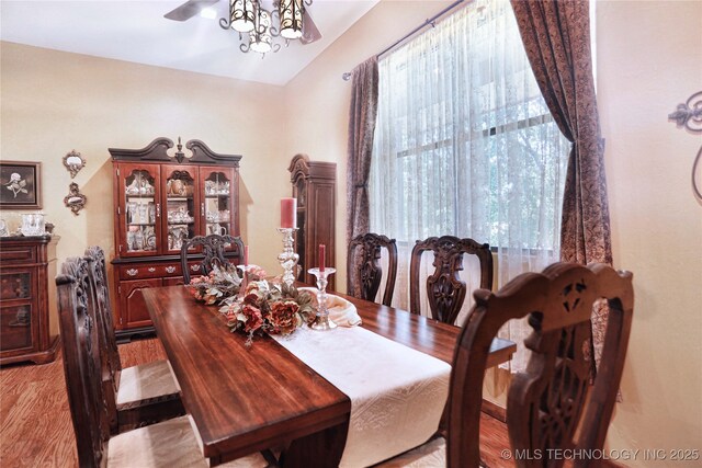 dining room with lofted ceiling, light wood-style floors, and a ceiling fan