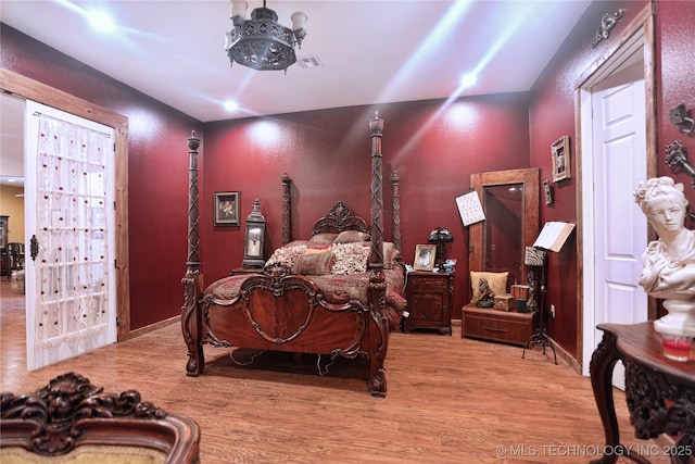 bedroom with wood finished floors