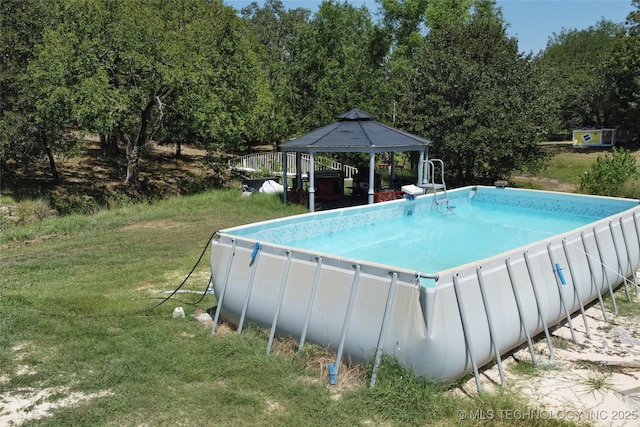 outdoor pool featuring a gazebo and a yard