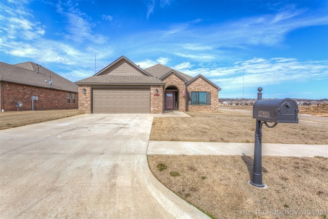 view of front of property featuring a garage, brick siding, a shingled roof, driveway, and a front yard