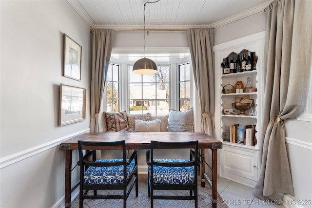 tiled dining space featuring breakfast area and crown molding