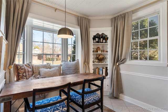 dining space with light tile patterned floors and baseboards