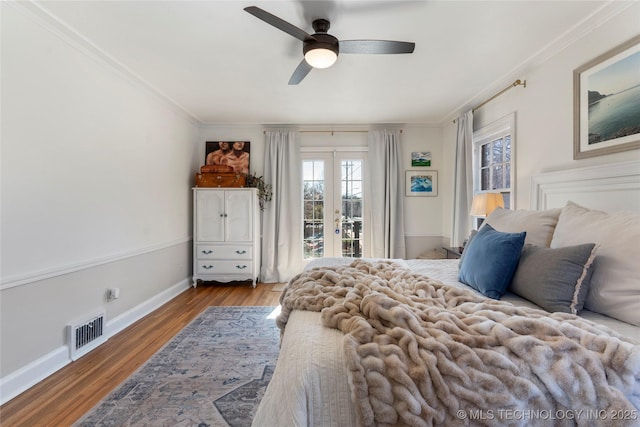 bedroom with access to exterior, visible vents, crown molding, and wood finished floors