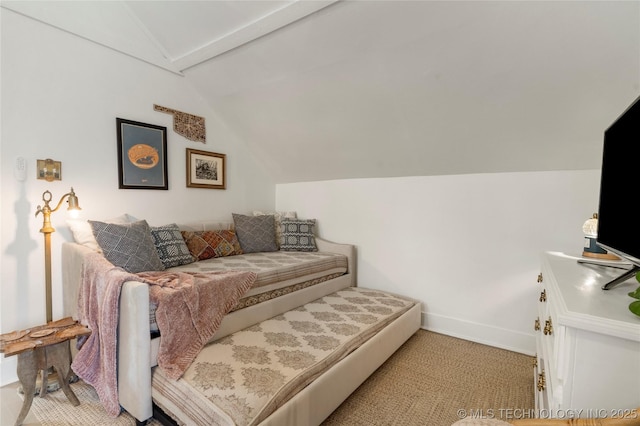 bedroom with vaulted ceiling and baseboards