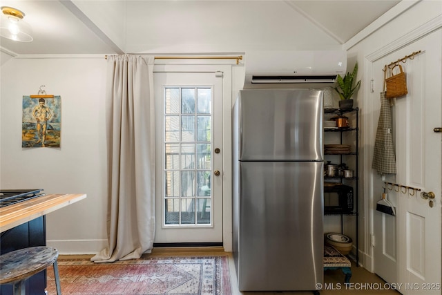 entryway featuring vaulted ceiling, baseboards, and a healthy amount of sunlight