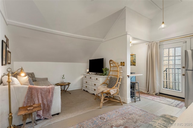 interior space featuring vaulted ceiling and baseboards