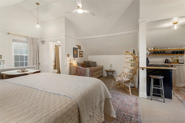 bedroom with lofted ceiling and ensuite bath