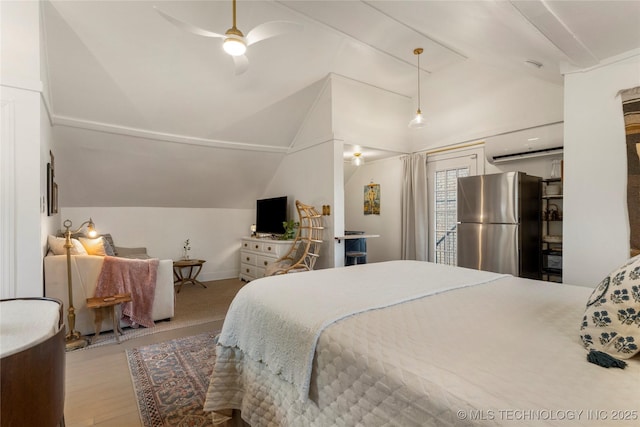 bedroom featuring lofted ceiling, a ceiling fan, freestanding refrigerator, an AC wall unit, and wood finished floors