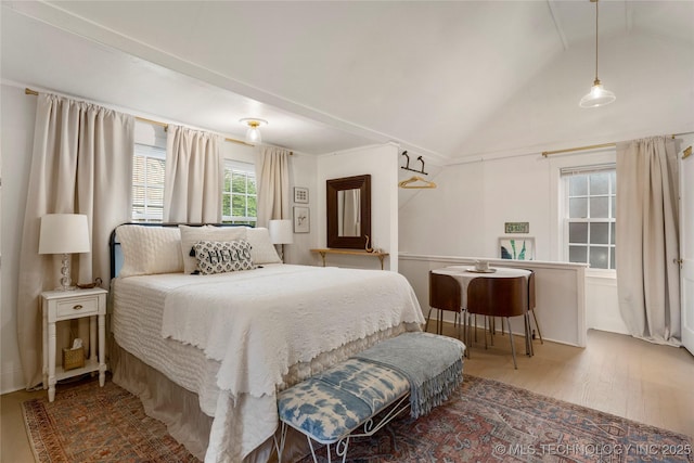 bedroom featuring vaulted ceiling and wood finished floors