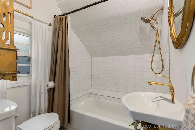 bathroom featuring shower / bath combination with curtain, a sink, and toilet