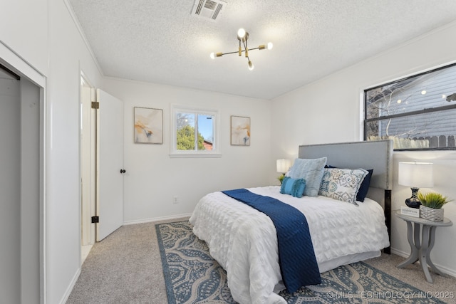 carpeted bedroom featuring a textured ceiling, visible vents, and baseboards