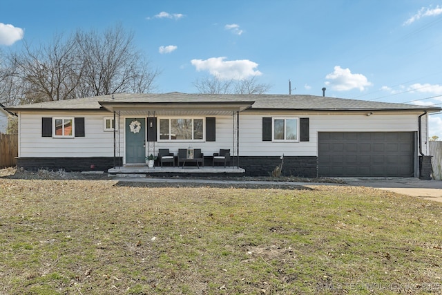 ranch-style house featuring a garage, a front yard, fence, and driveway