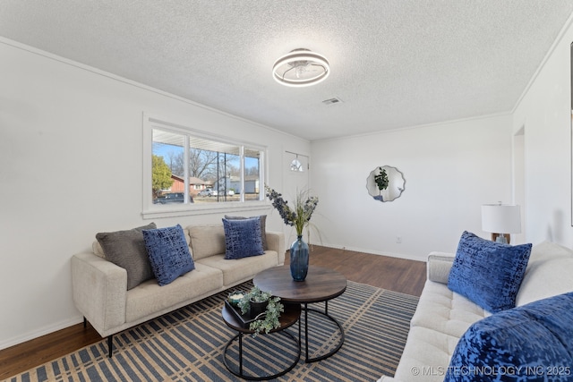 living area featuring a textured ceiling, baseboards, and wood finished floors