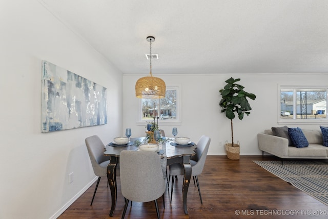 dining area featuring baseboards, plenty of natural light, visible vents, and wood finished floors