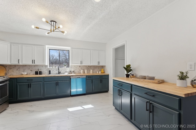kitchen featuring marble finish floor, wooden counters, white cabinetry, a sink, and dishwasher