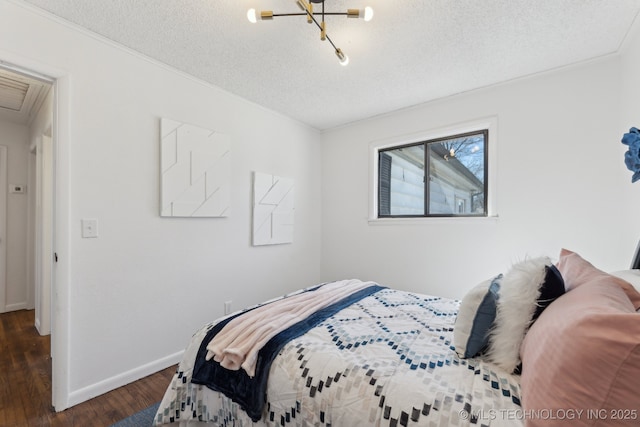 bedroom with a textured ceiling, baseboards, and dark wood-style flooring
