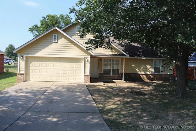 view of front of home with a garage, concrete driveway, and brick siding