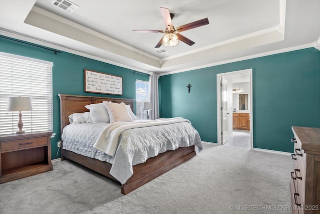 bedroom with carpet, visible vents, a raised ceiling, and crown molding