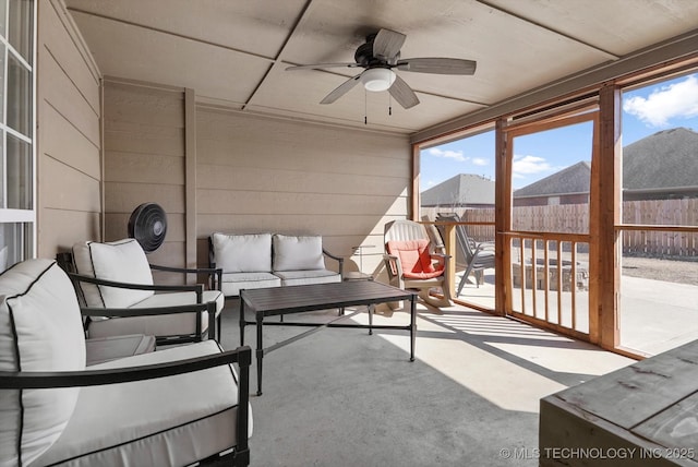 sunroom with a ceiling fan