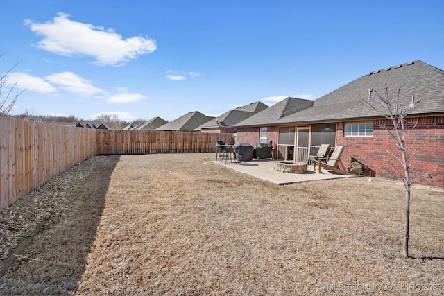 view of yard featuring a fire pit, a patio, and a fenced backyard