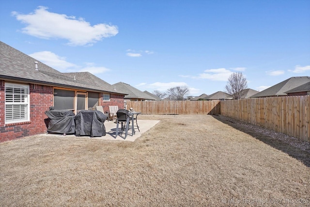 view of yard with a patio area and a fenced backyard