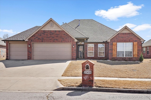 view of front of house with a garage, concrete driveway, brick siding, and a shingled roof