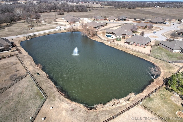 drone / aerial view with a water view and a residential view