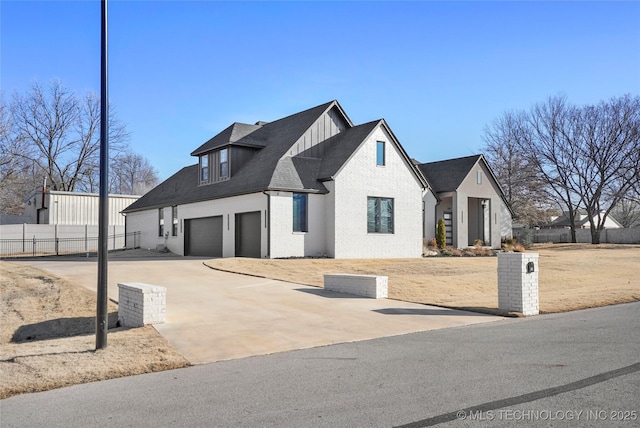 modern inspired farmhouse featuring a garage, brick siding, fence, concrete driveway, and board and batten siding