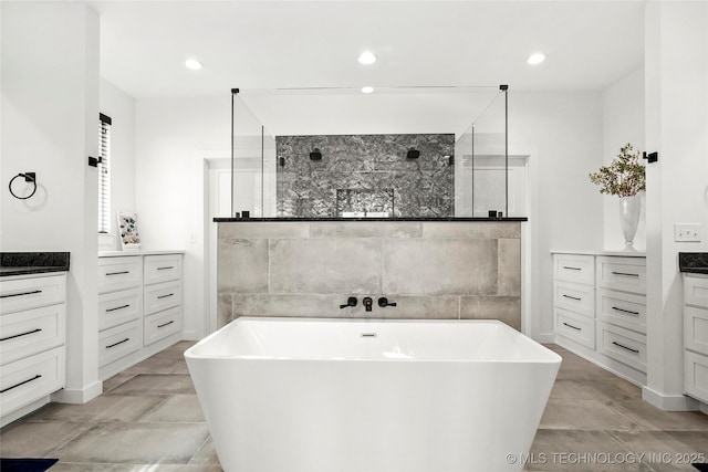 bathroom with a freestanding tub, walk in shower, and recessed lighting